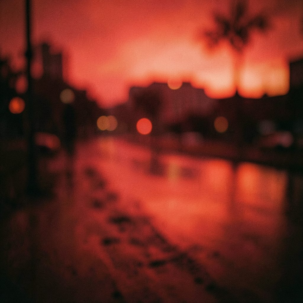 A photographer's silhouette against a golden-hour cityscape, warm orange and deep blue tones, wide cinematic framing